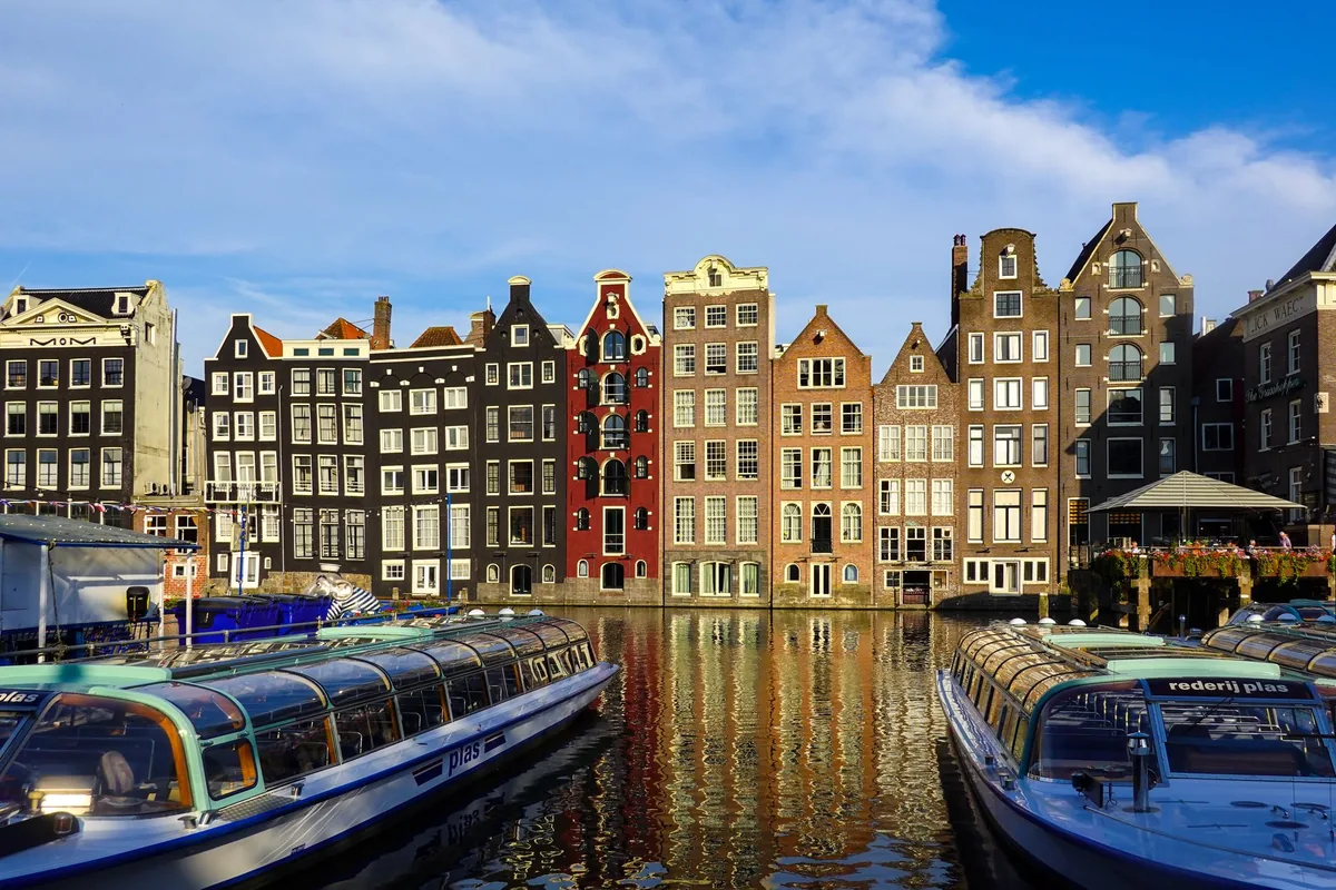 Colourful gabled canal houses along an Amsterdam canal in the Netherlands, illustrating Dutch income tax
