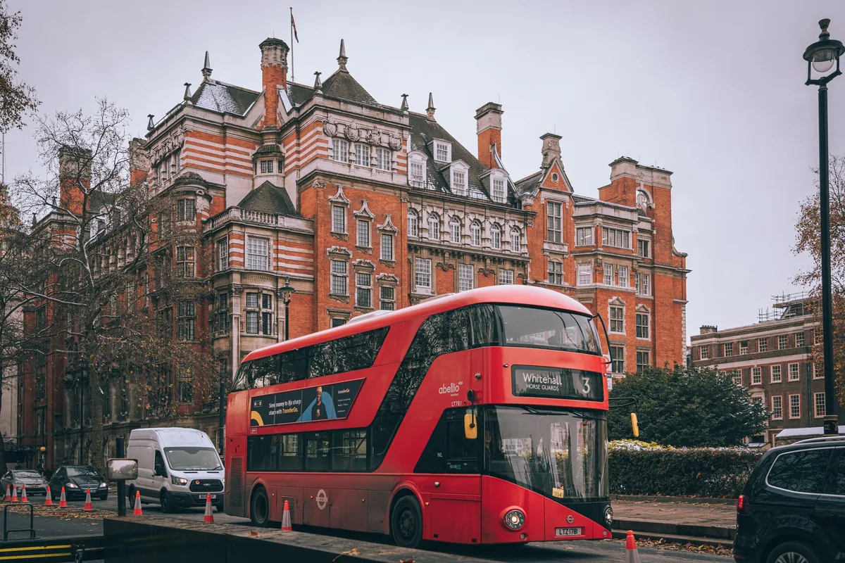 Red double-decker bus on a central London street, illustrating the UK 60% tax trap for high earners