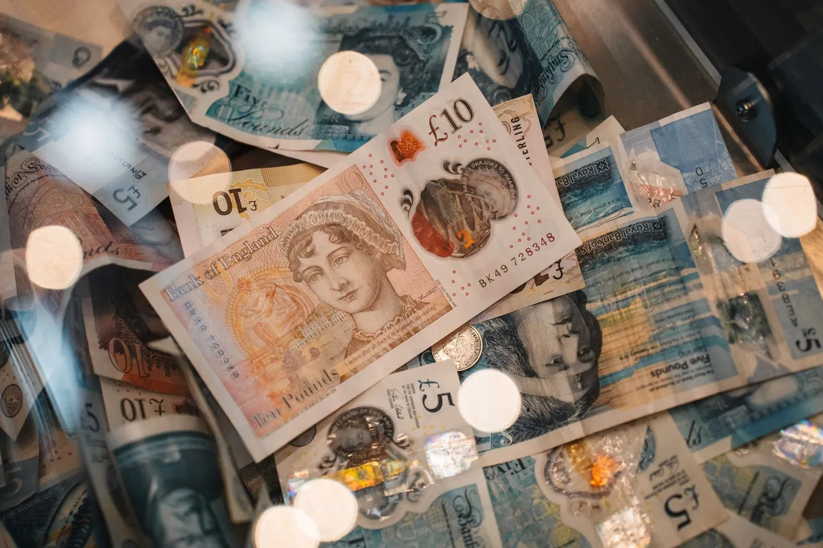 British pound sterling banknotes and coins, illustrating UK salary tax and take-home pay calculations