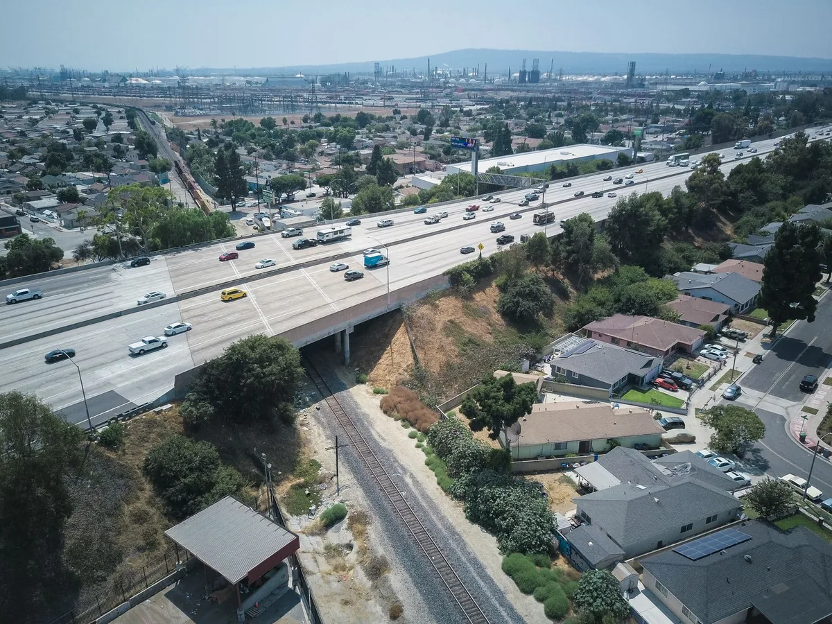 Aerial view of a busy US freeway crossing a suburban neighbourhood with single-family homes